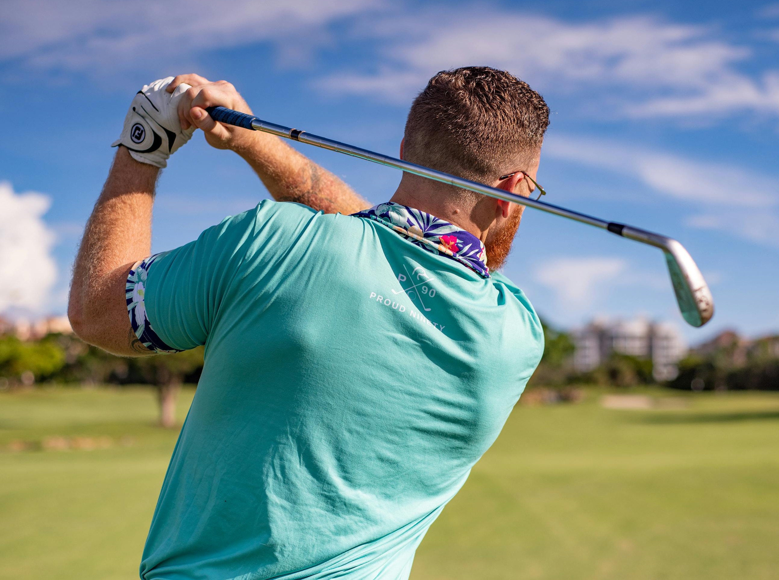 golfer finishing swing. view from his back